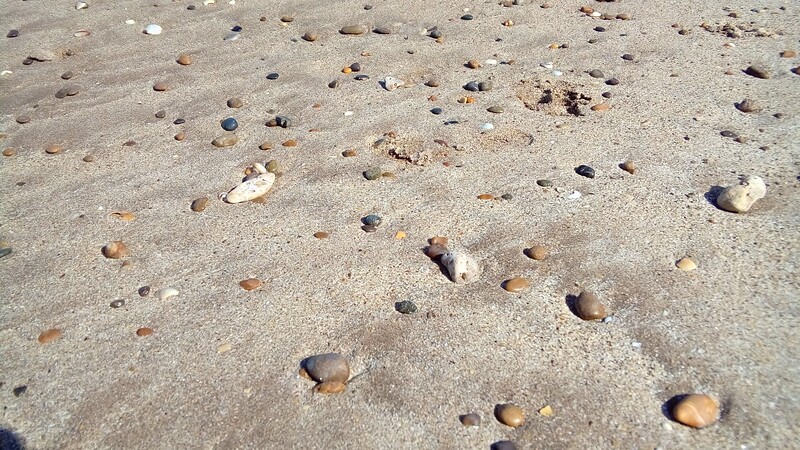 sand-and-stones-on-a-beach-opt